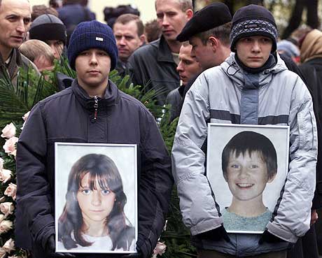To russiske gutter holder portretter av barne-skuespillerne Arseny Kurilenko (13) og Kristina Kurbatova (13) som ble begravet i Moskva onsdag 30. oktober. De to døde etter gisselaksjonen i forrige uke. (Foto: Reuters/Alexander Natruskin)