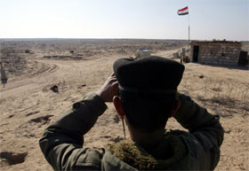 En irakisk soldat speider over grensen til Kuwait, der de amerikanske styrkene gjør seg klar til invasjon. (Foto: Faleh Kheiber, Reuters)