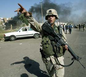 Ein amerikansk soldat omdirigerer trafikken etter en eksplosjon. (Foto: Suhaib Salem / Reuters / Scanpix) 
