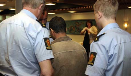 Den tiltalte i drapsaken blir følgt ut av to politibetjenter under en pause i rettsaken som gikk i Valdres tingrett. (foto: Scanpix)