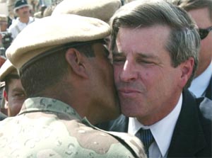 Den amerikanske lederen av siviladministrasjonen i Irak, Paul Bremer, får kyss på kinnet av en irakisk soldat. (Foto: AP/Scanpix) 