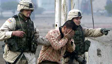 Amerikanske soldater hjelper en grtende mann bort fra stedet hvor bomben gikk av.  Foto: David  Guttenfelder, AP