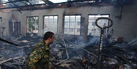 En brannmann undersøkte restene av den utbrente gymsalen ved Beslan-skolen der over 1000 gisler ble holdt. Foto: AFP/Scanpix.