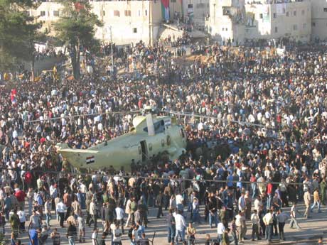 Tusenvis av palestinere stormet den åpne plassen da helikopteret med Yasir Arafats kiste landet i Ramallah. (Foto: Odd Karsten Tveit/NRK)