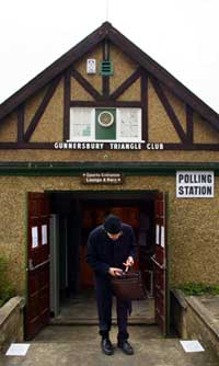FERDIG STEMT: En mann forlater valglokalet i Gunnersbury i vest-London etter å ha avgitt sin stemme. (Foto: AFP)