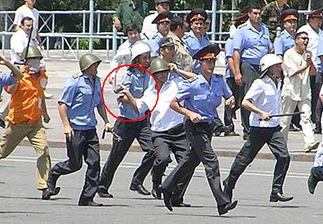 Opprørspoliti kastet stein mot demonstranter i Kirgisistans hovedstad Bisjkek i dag. (Foto: NRK)