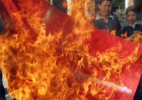 Palestinske ungdommer i Jerusalem brenner et dansk flagg i raseri over Muhammed-karikaturene. (Arkivfoto: Mahfouz Abu Turk/ Reuters/ Scanpix)